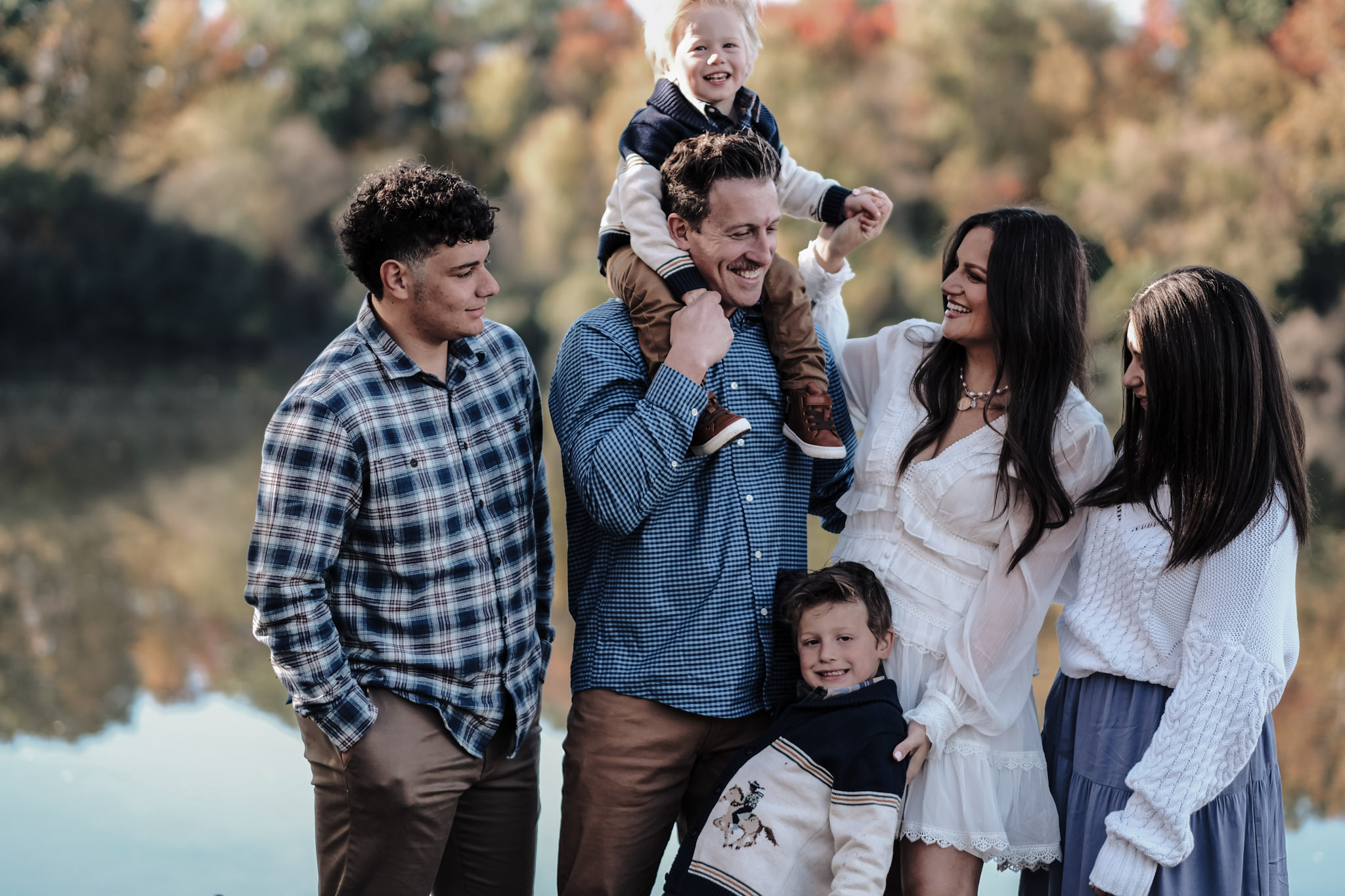 Family laughing together during outdoor portrait session